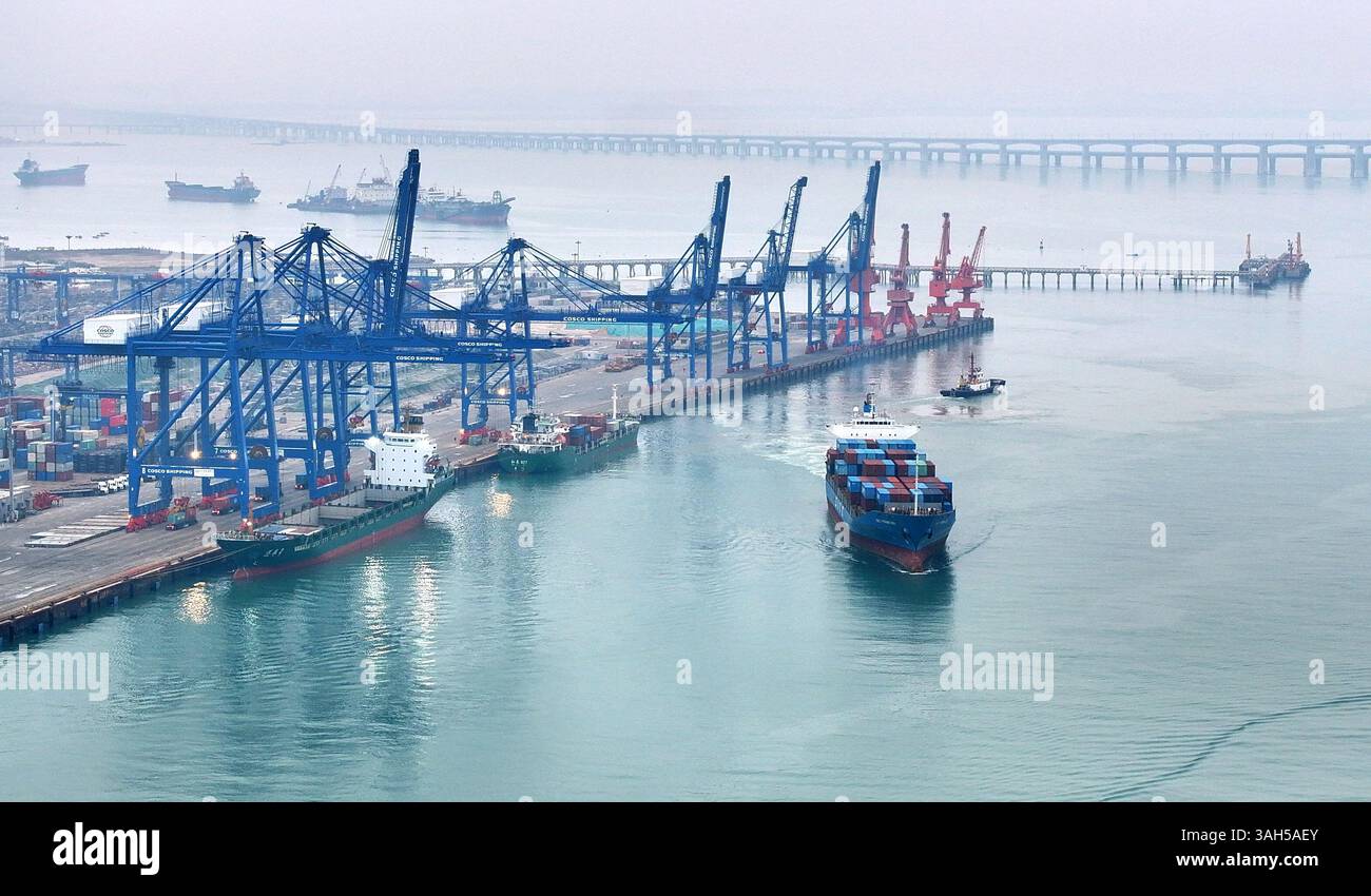 SHISHI, CHINA - APRIL 5, 2025 - Cargo ships load and unload containers ...