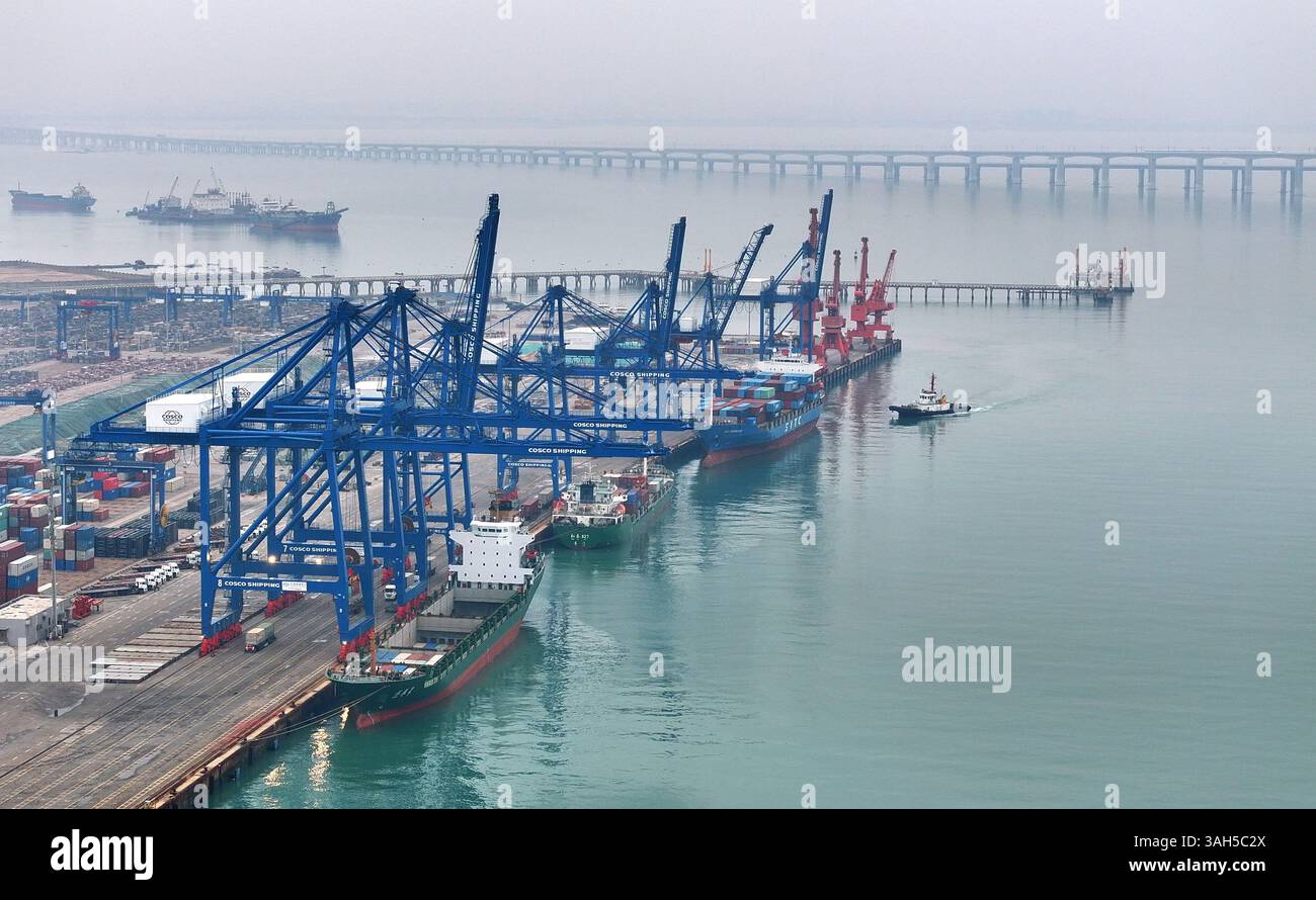 SHISHI, CHINA - APRIL 5, 2025 - Cargo ships load and unload containers ...