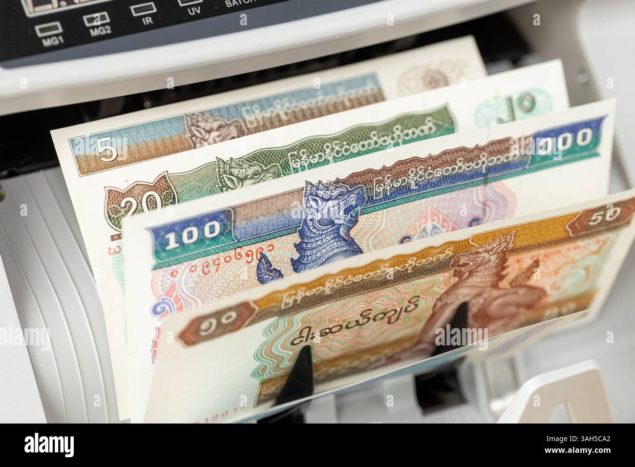 Myanmar money, Burmese kyat counting machine. Financial background, business concept, close up Stock Photo