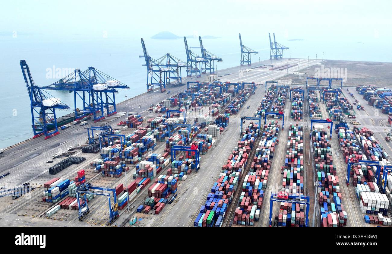 SHISHI, CHINA - APRIL 5, 2025 - Cargo ships load and unload containers ...