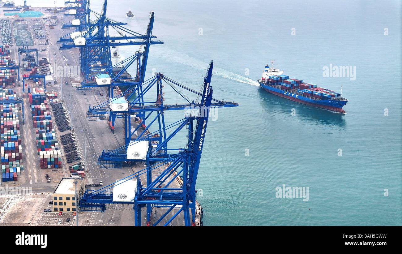 SHISHI, CHINA - APRIL 5, 2025 - Cargo ships load and unload containers ...