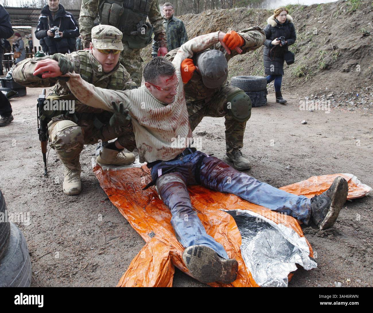 March 31, 2015 - Kiev, Ukraine - Kiev officials and volunteers tend a mock victim during a training session with tactical medicine for civilians on a shooting range outside of Kiev. For participants simulate real situations and providing emergency medical care and civil defense in emergency situations  (Credit Image: © Serg Glovny/ZUMA Wire/ZUMAPRESS.com) Stock Photo