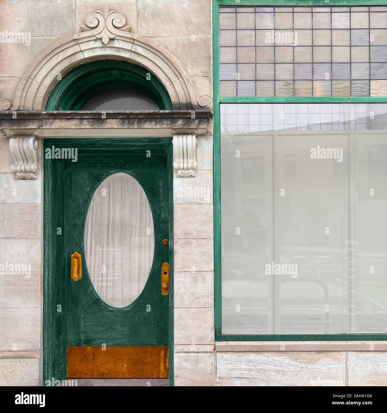 Green door with oval frosted glass, decorative archway detail, set in a stone facade next to large framed glass windows in a historic Chicago streets. - Smartphone Captured Stock Image
