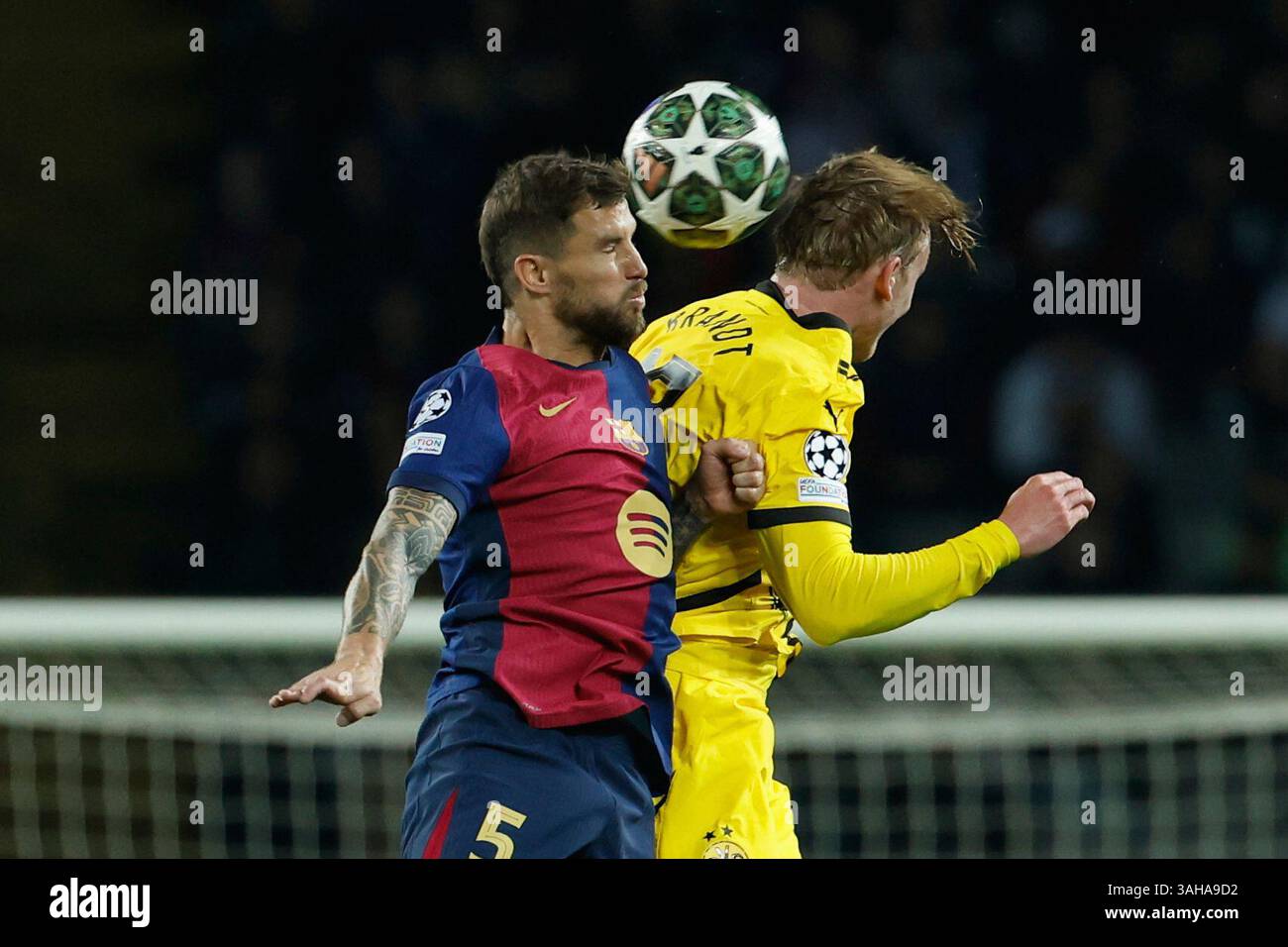 Julian Inigo Barcelona's Inigo Martinez, left, duels for the ball with Dortmund's ...