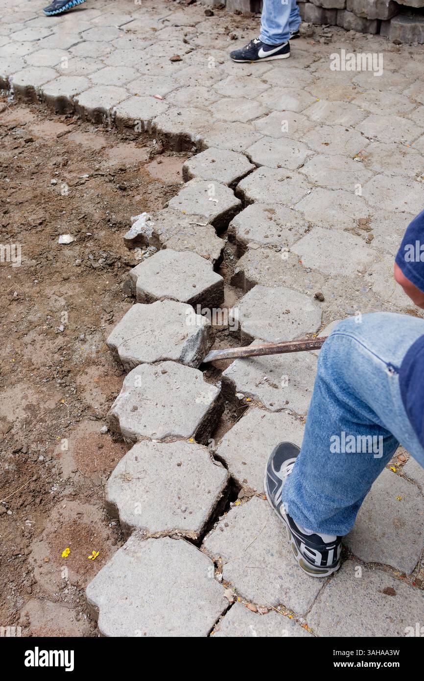 Breaking out concrete blocks to build barricades for neighborhood ...