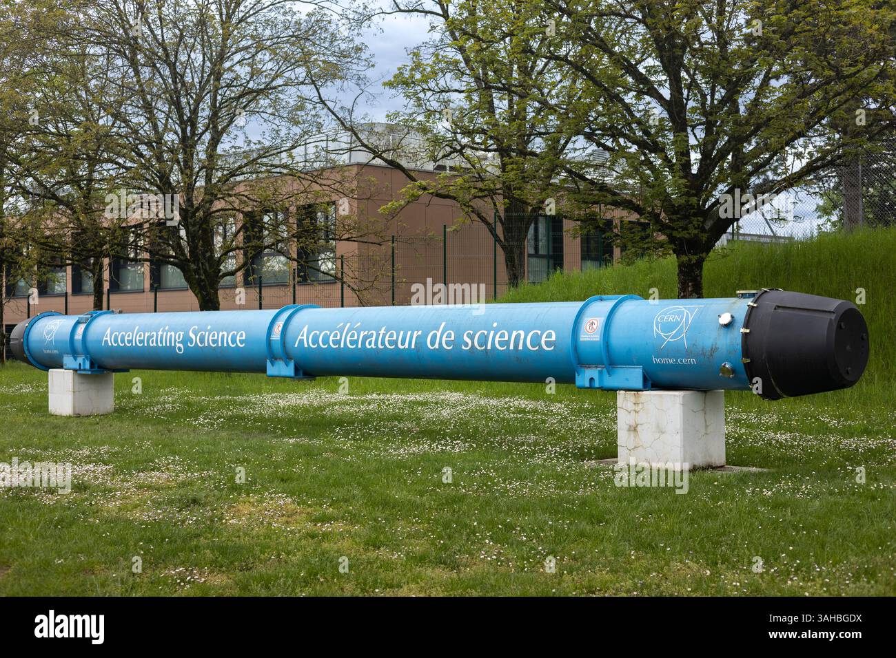 A blue model of a particle accelerator with the words Accelerating ...