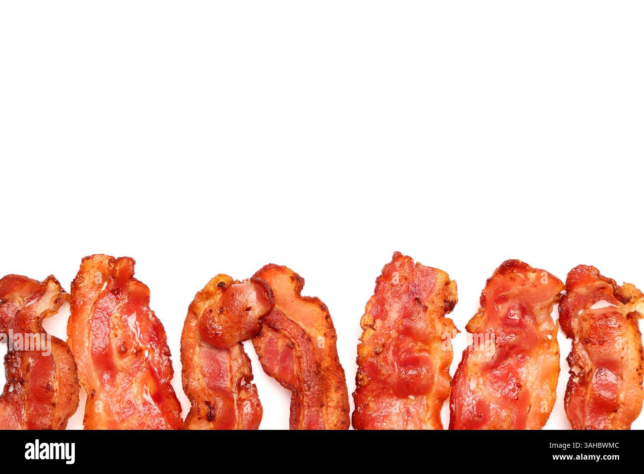 Many fried bacon rashers on white background Stock Photo - Alamy