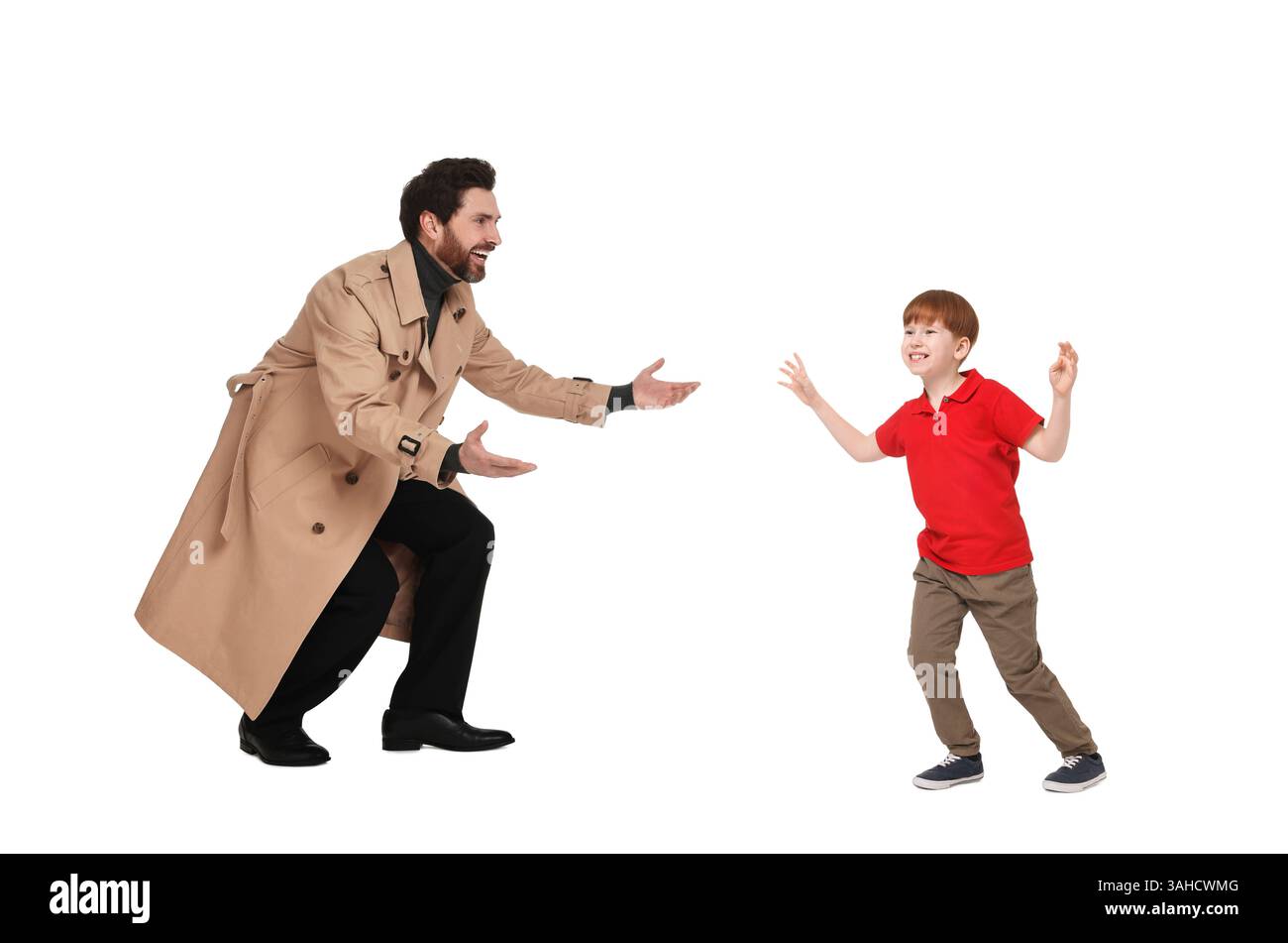 Happy boy walking towards his father on white background Stock Photo