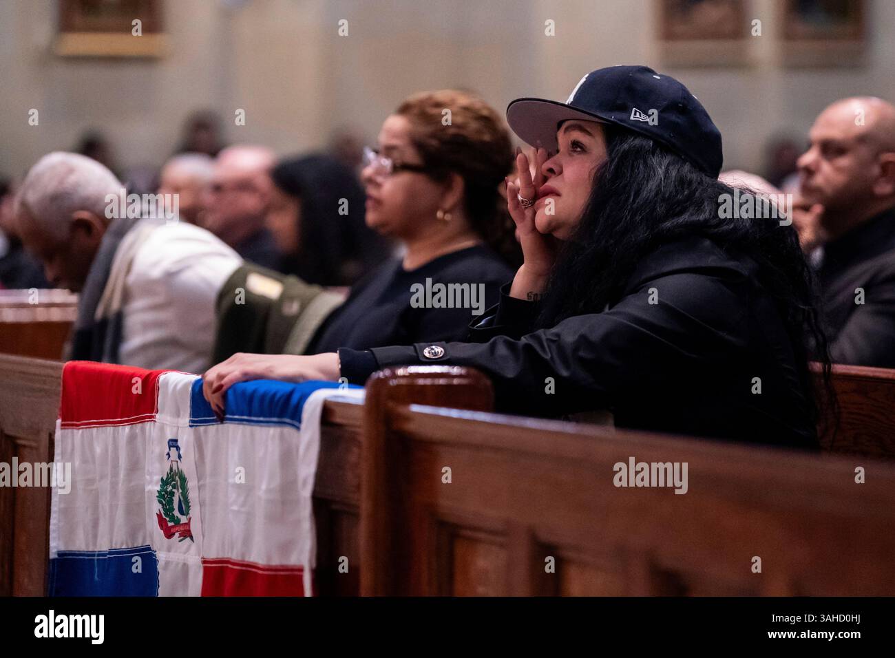 A person cries as people attend a Mass for the victims of the Jet Set ...