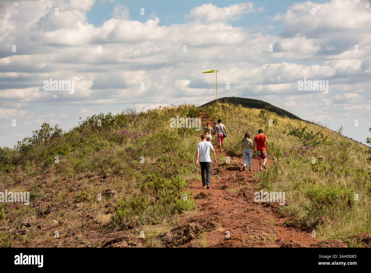 Group of people seen from behind walking on the trails on top of a ...