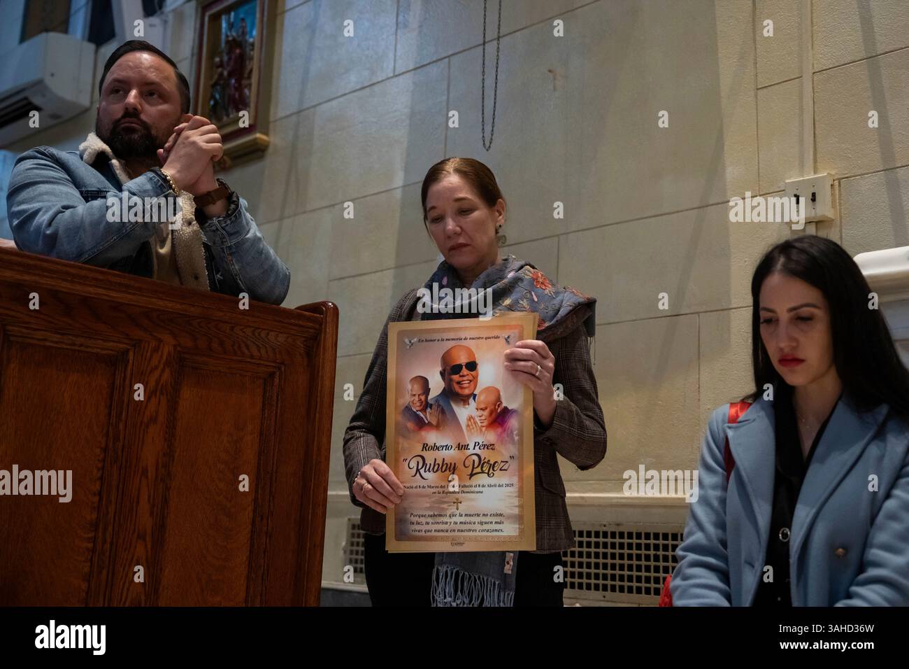 People attend a Mass, holding an image of Rubby Perez, for the victims ...
