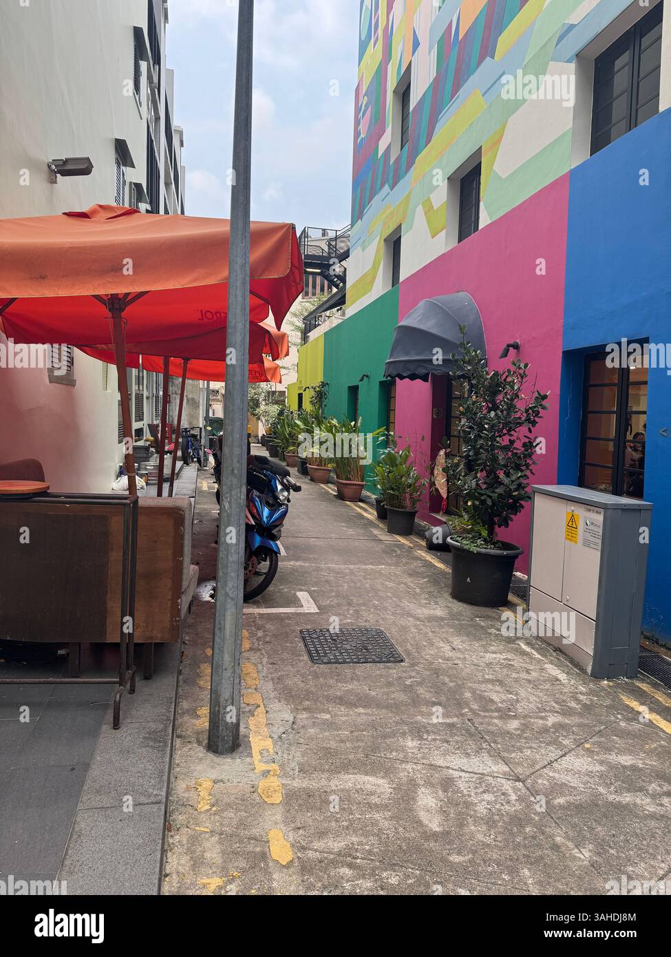 Colorful backstreet in Singapore with vibrant building facades. Urban charm meets tropical creativity in this lively city corner. Stock Photo