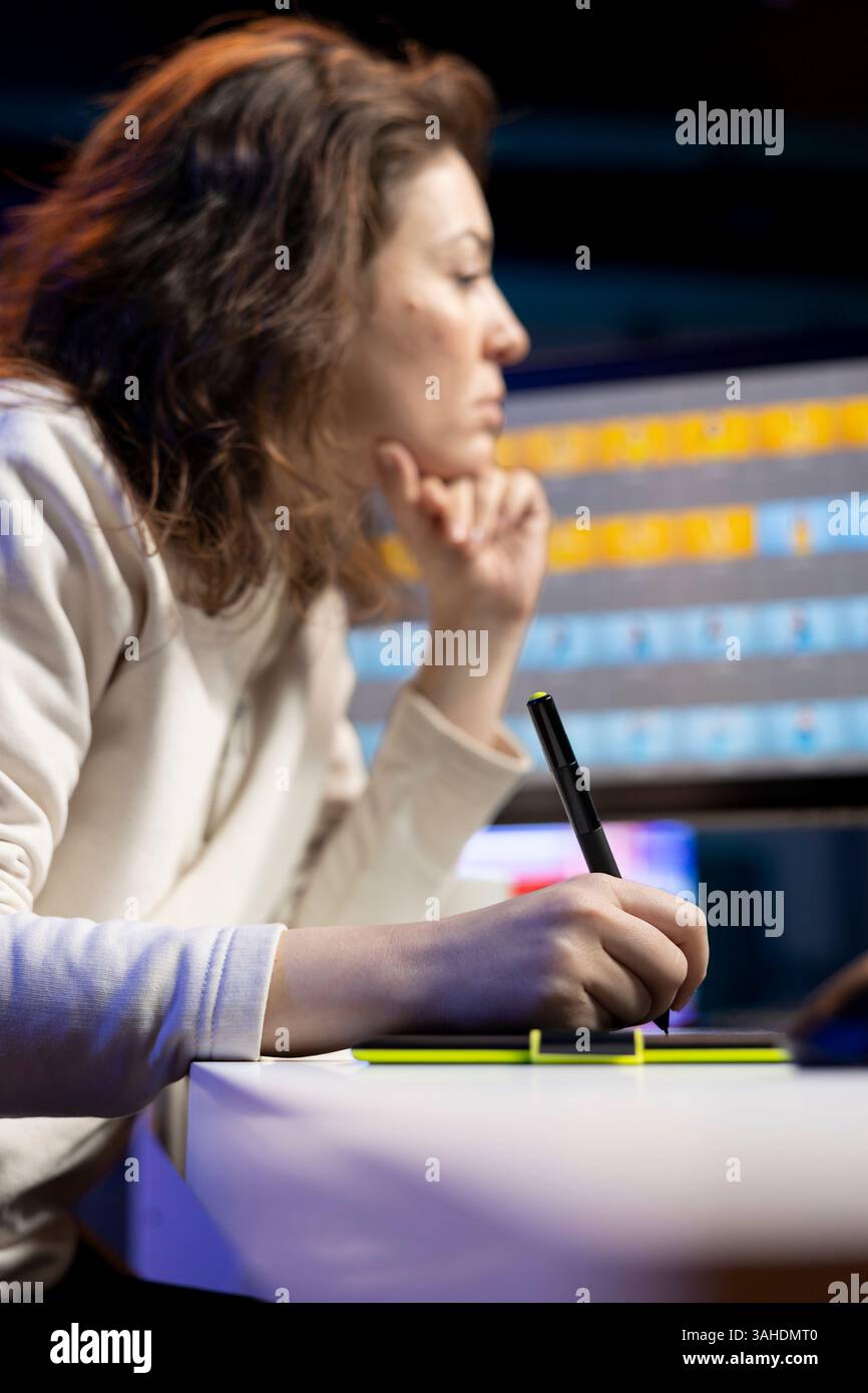 Photo editor color correcting photographs in creative studio using ...