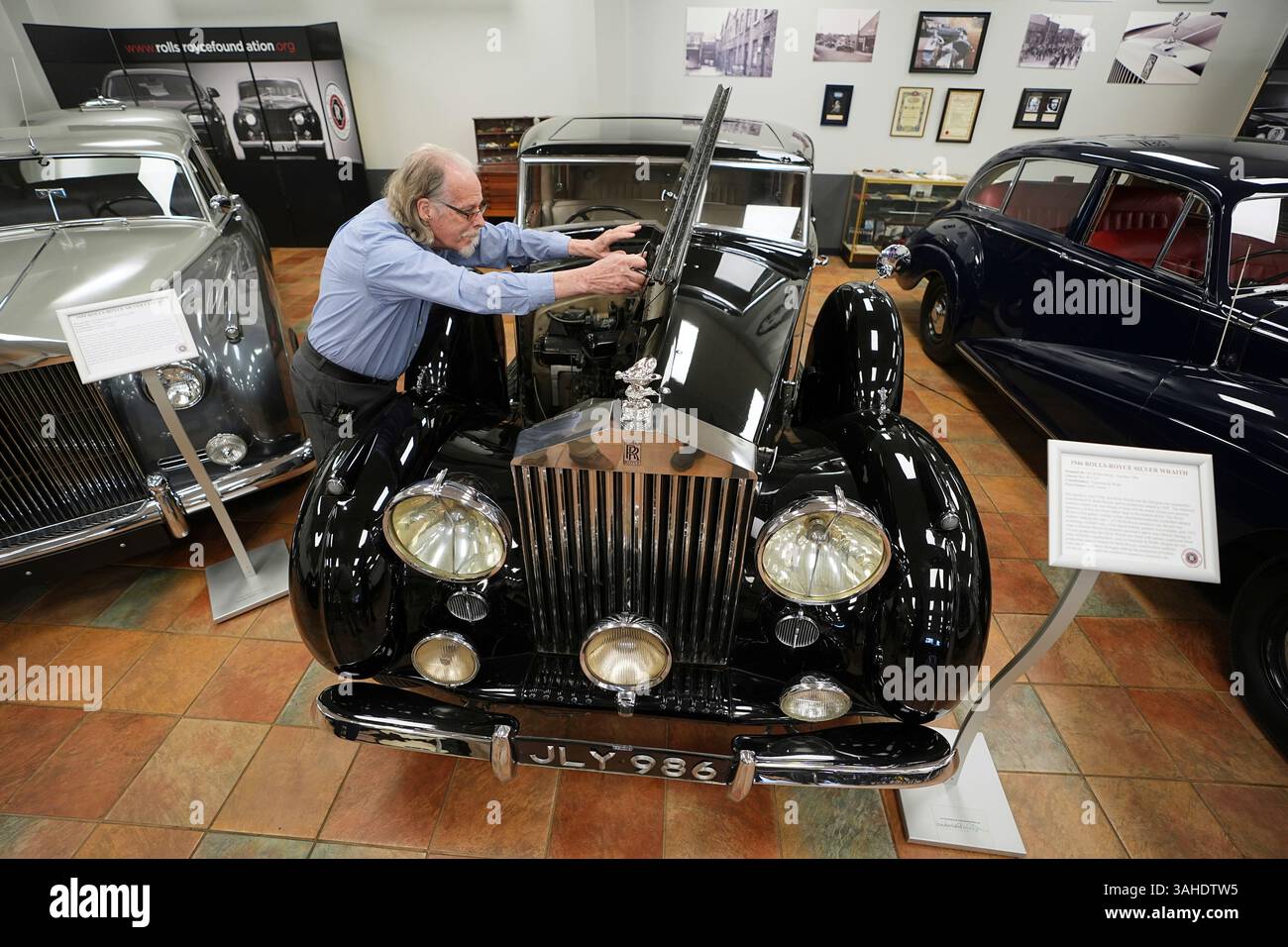 Tommy Tate opens the hood of a 1946 Rolls-Royce Silver Wraith during an ...