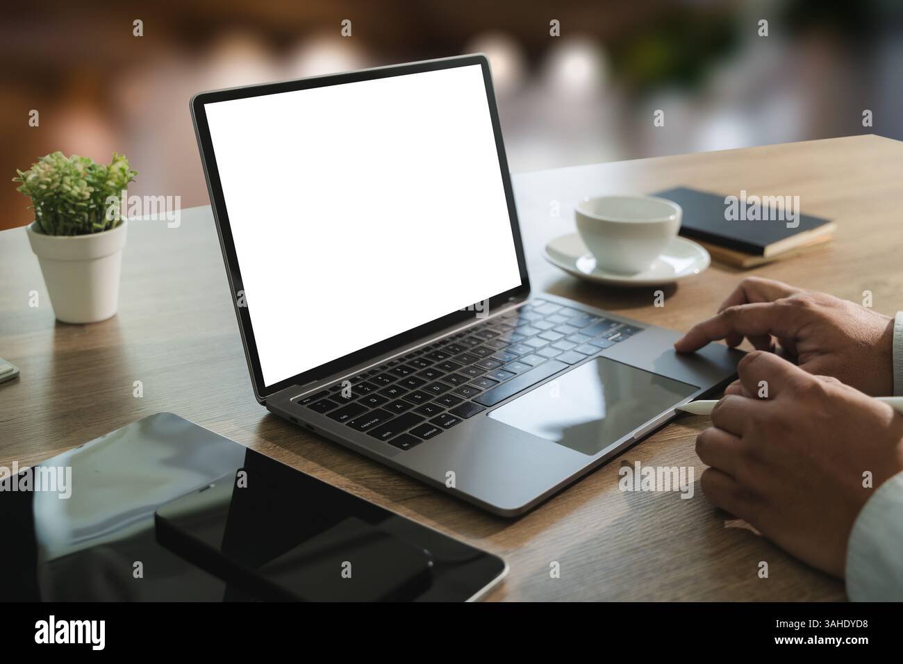 mock up Using laptop with blank screen computer modern young man using computer at workplace Stock Photo