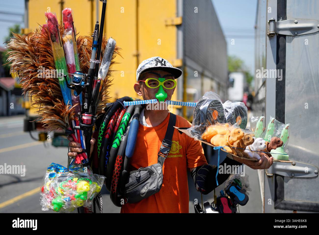 Filipino Andy Chavez peddles different kinds of goods to motorists ...