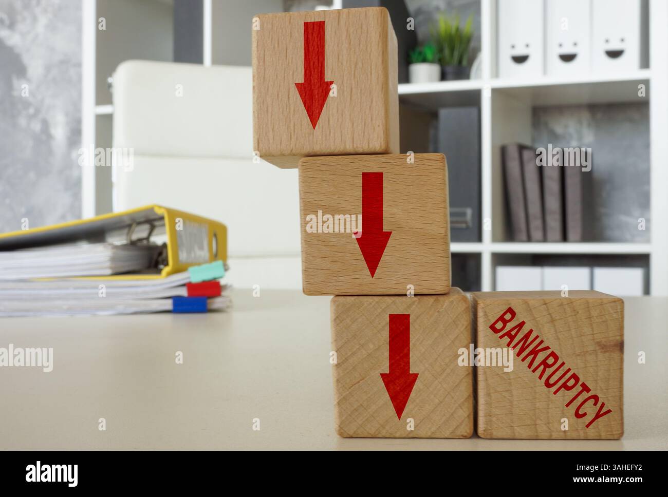 Downward arrows and the word bankruptcy. Stock Photo