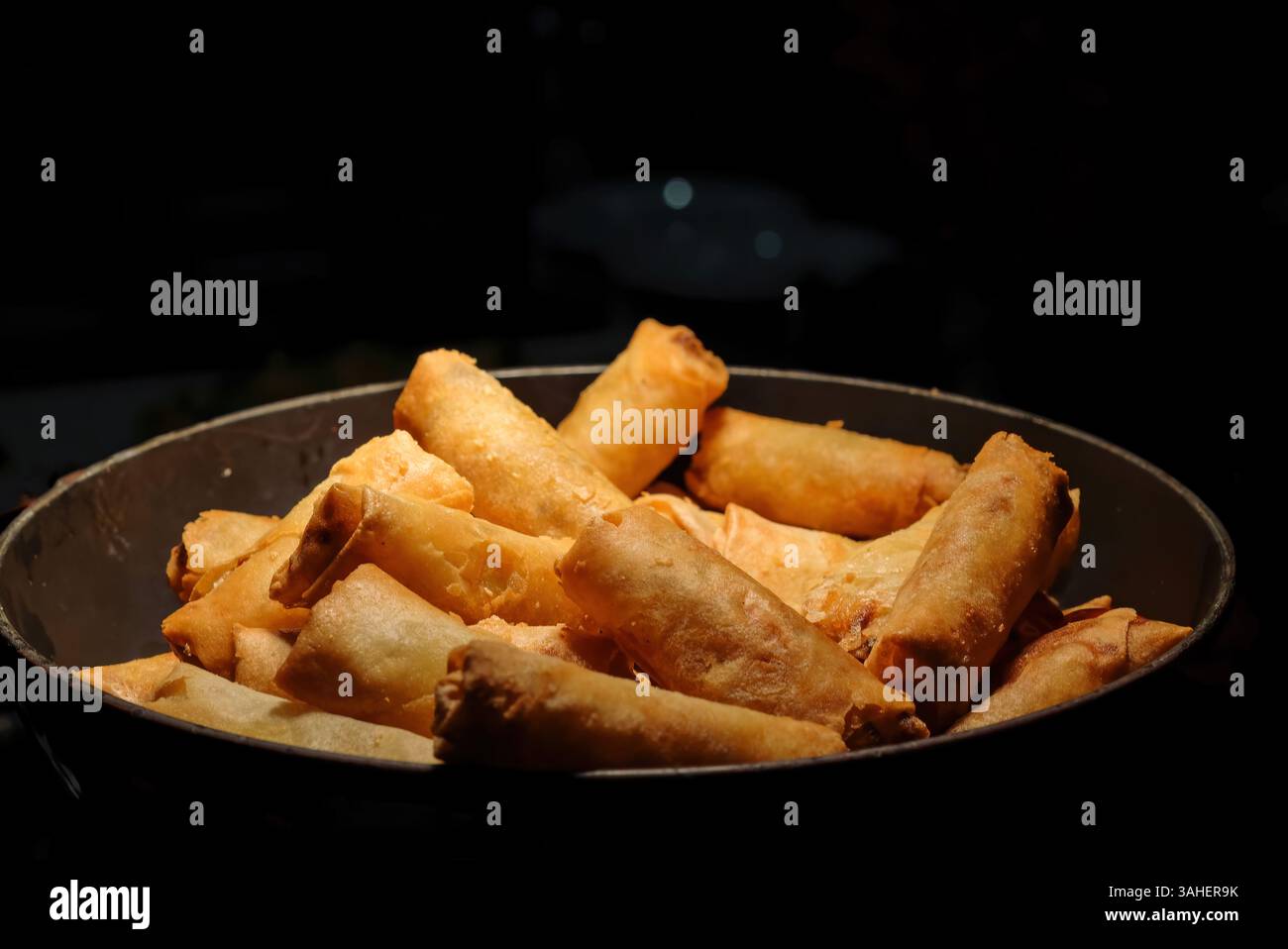 deep fried spring rolls  surve on the pan in dark background Stock Photo
