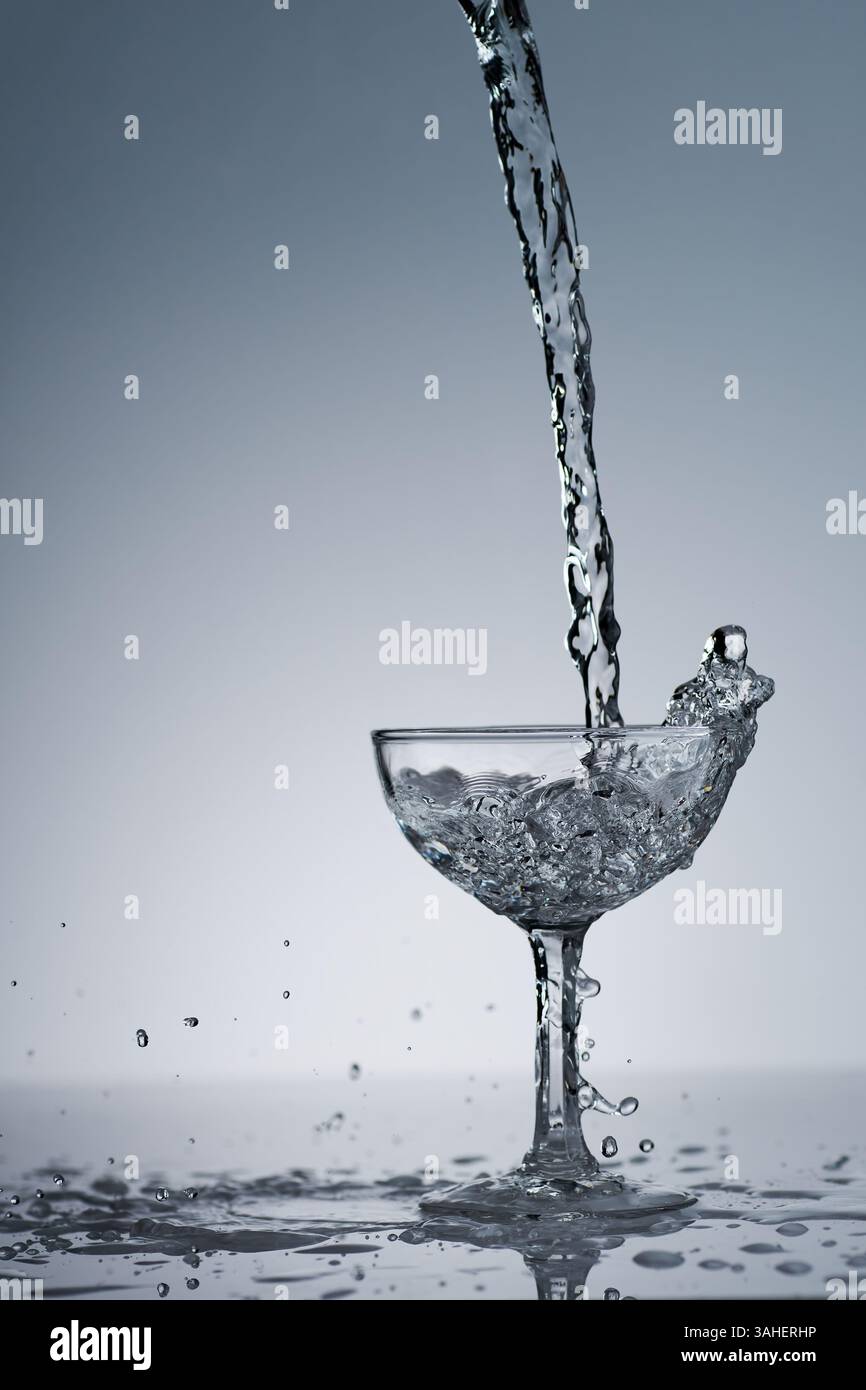 puring refreshment freshness drinking water on clean transperence glass in studio back light Stock Photo