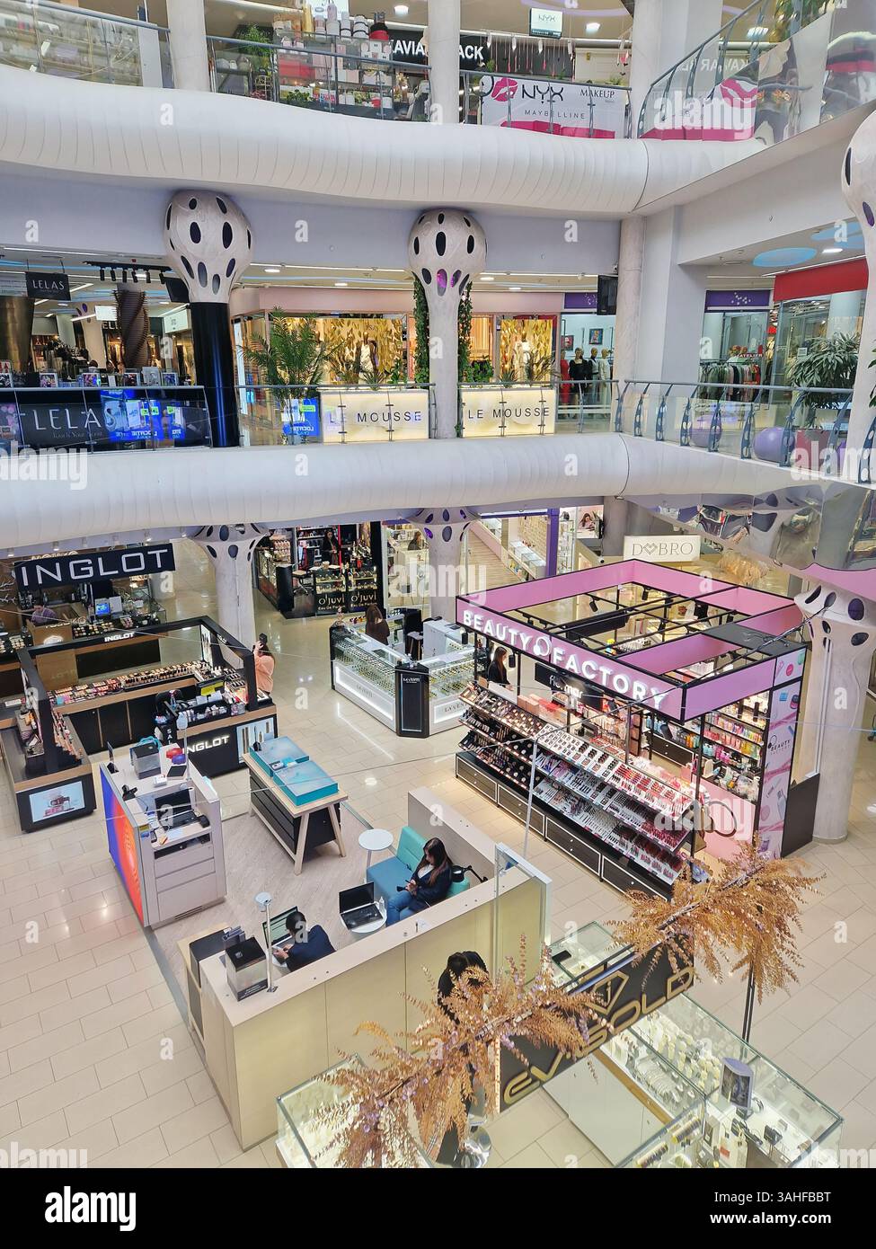 CHISINAU, MOLDOVA - OCTOBER 28, 2024 Shopping mall with various stores, unique architecture and a modern design. Atrium commercial center indoors - Smartphone Captured Stock Image