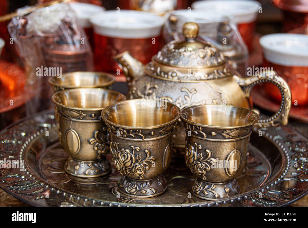 Vintage copper tea set displayed elegantly in a traditional shop window ...