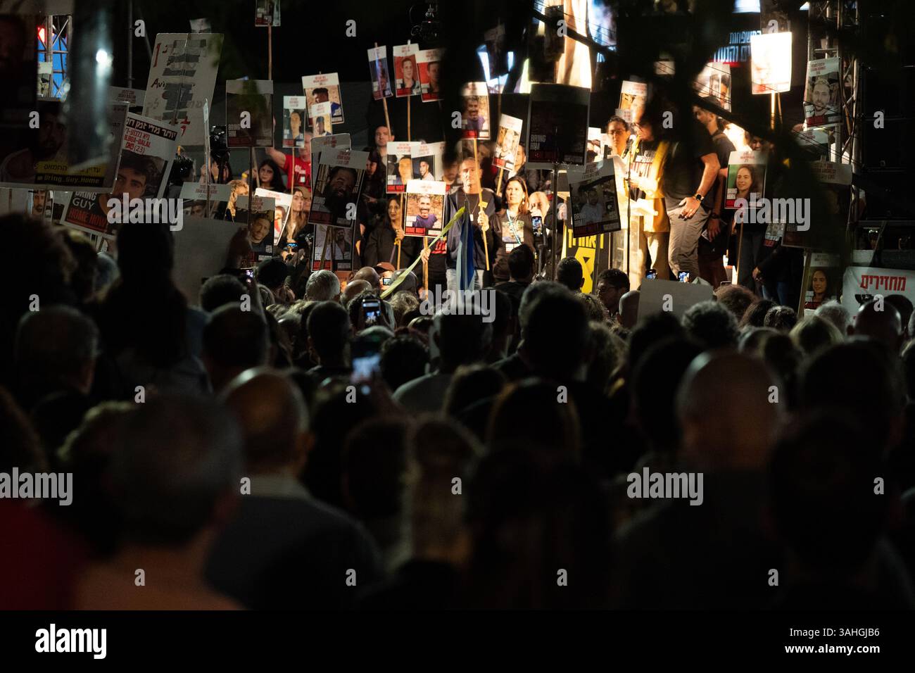 Crowd gathers at Hostage Square in Tel Aviv on April 5, 2025, as families of hostages hold signs and demand a ceasefire to secure their release. Stock Photo