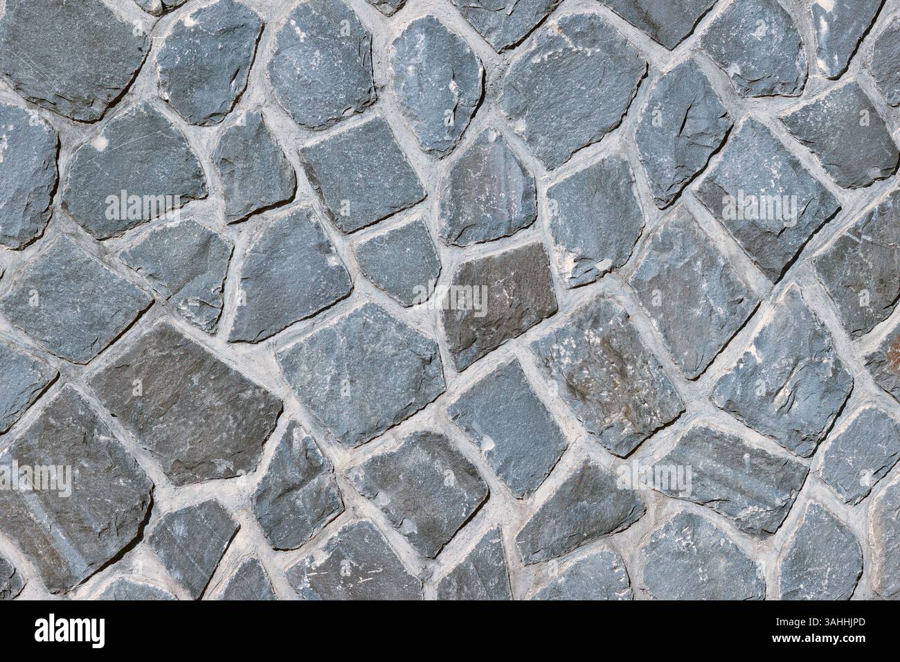 wall of grey natural stones as background Stock Photo