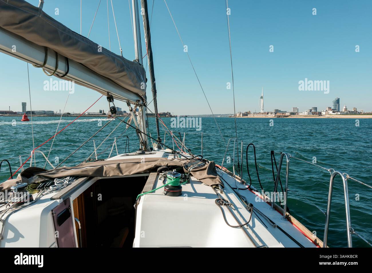 9 April 2025 - Sailing into Portsmouth Harbour in the Solent, through the small ships channel, passing the Spinnaker Tower Stock Photo