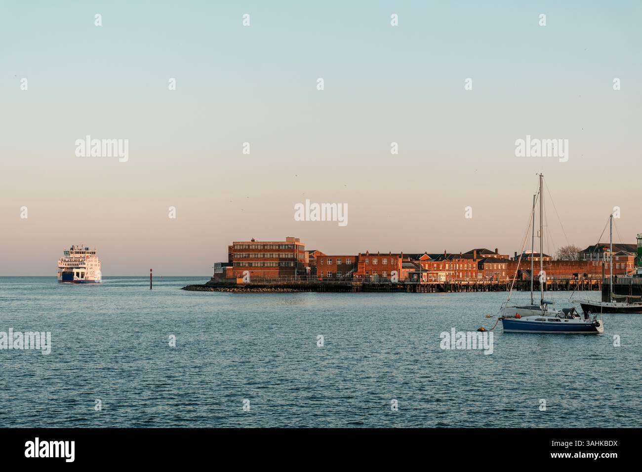 9 April 2025 - Portsmouth, UK - The Harbour entrance at Portsmouth Harbour, viewed from the sea with a ferry passing. Stock Photo