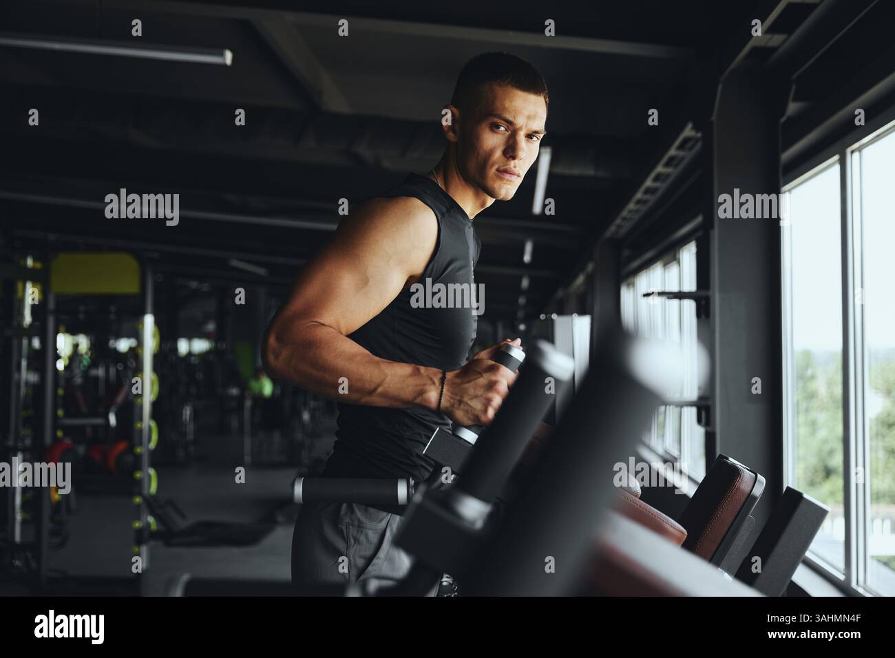 Bodybuilder Training Handsome muscular bodybuilder preparing for an intense workout on ...