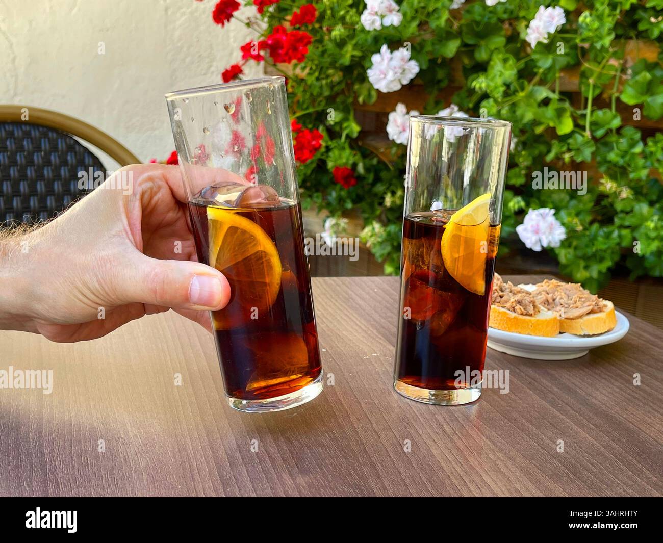 Hand holding a glass of vermouth. Spain. - Smartphone Captured Stock Image