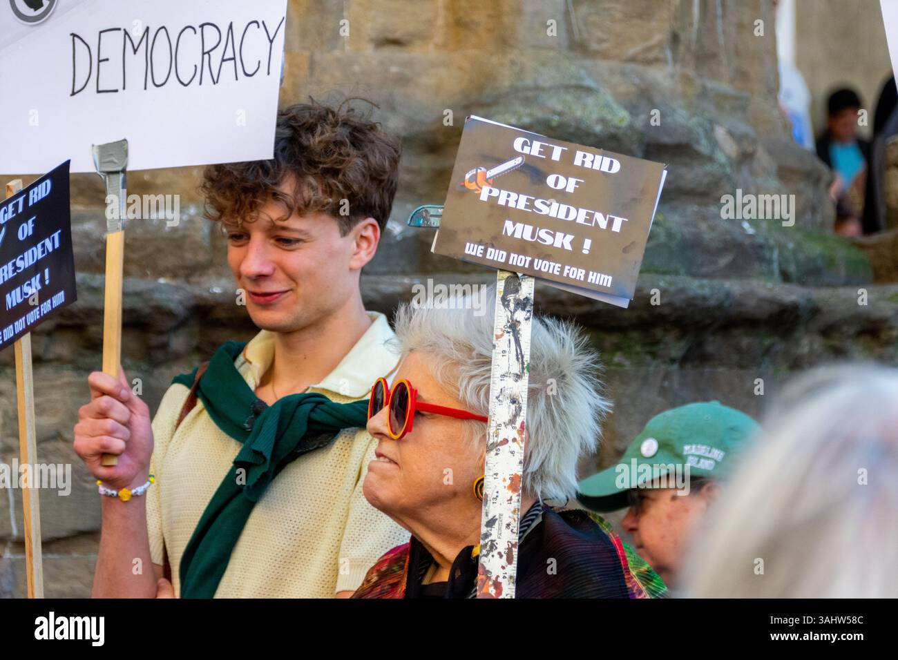 'Hands Off!' protest at Piazza della Signoria, Florence, opposing Trump and Musk’s DOGE policies, defending democracy and public services. Stock Photo