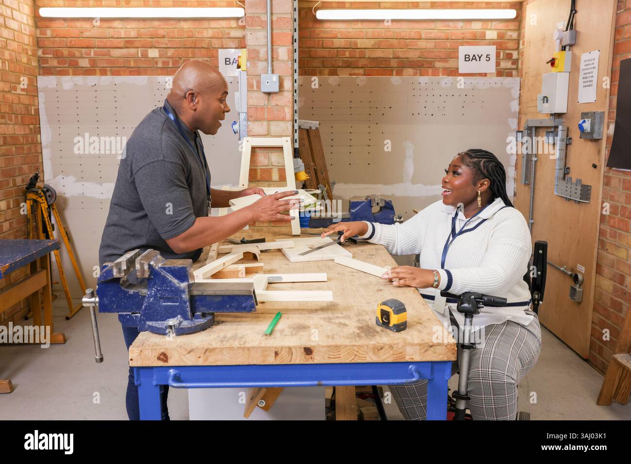 Disabled man and woman working in workshop Stock Photo