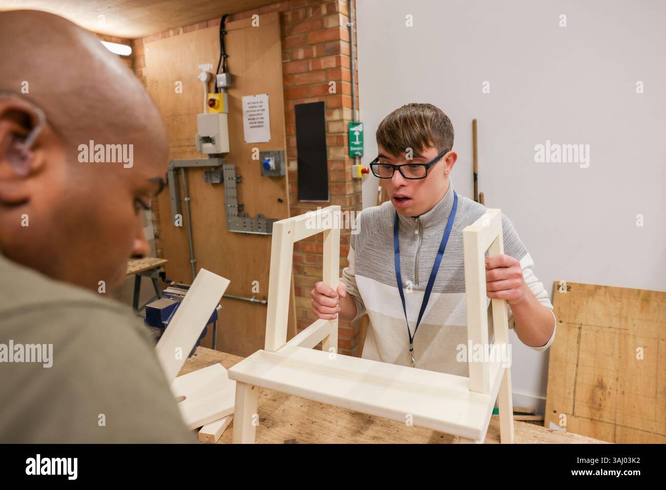 Disabled men working in workshop Stock Photo