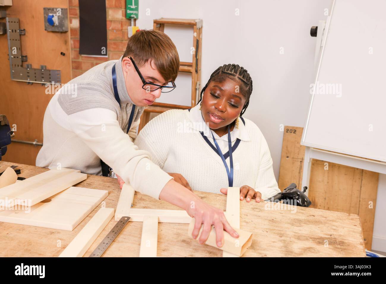 Disabled man and woman working in workshop Stock Photo