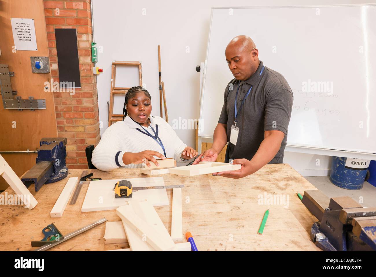 Disabled man and woman working in workshop Stock Photo
