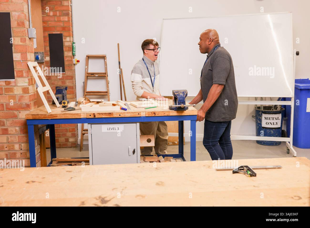 Disabled men working in workshop Stock Photo