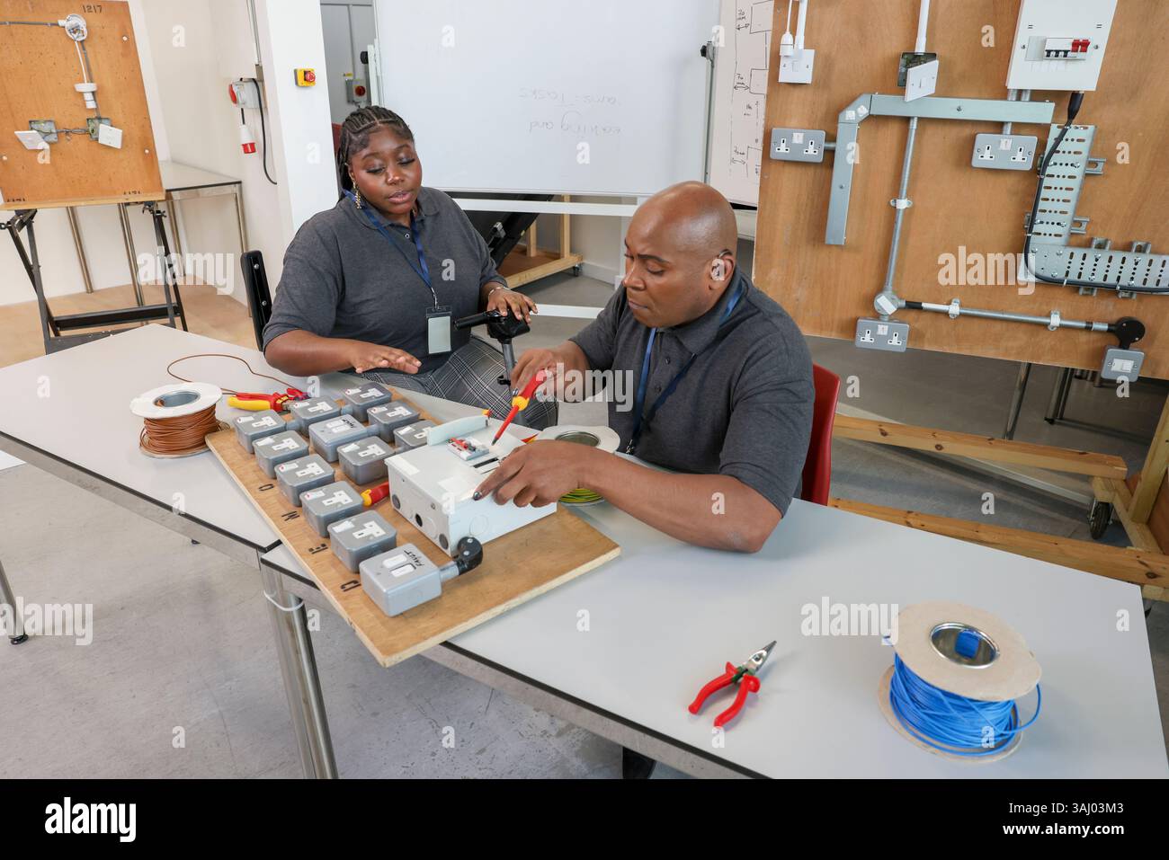 Disabled man and woman working in workshop Stock Photo