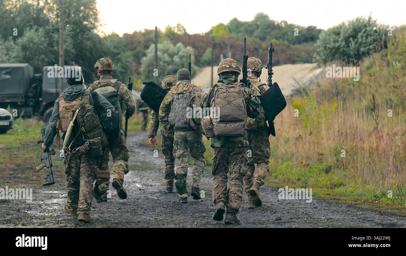 Soldiers on Patrol in Rural Area. Group of armed soldiers in camouflage ...