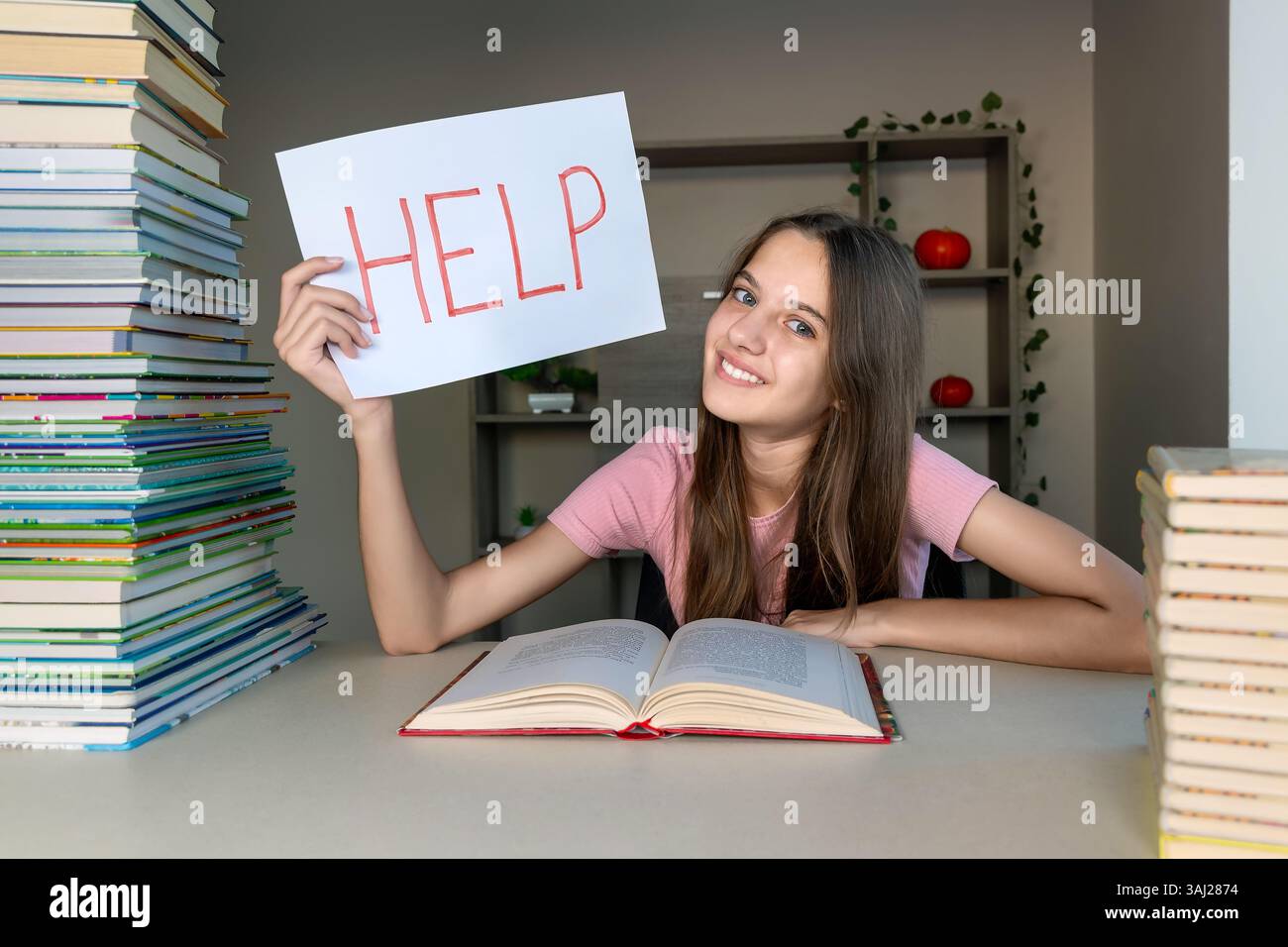 Student overwhelmed by study work holding a help sign. A student ...