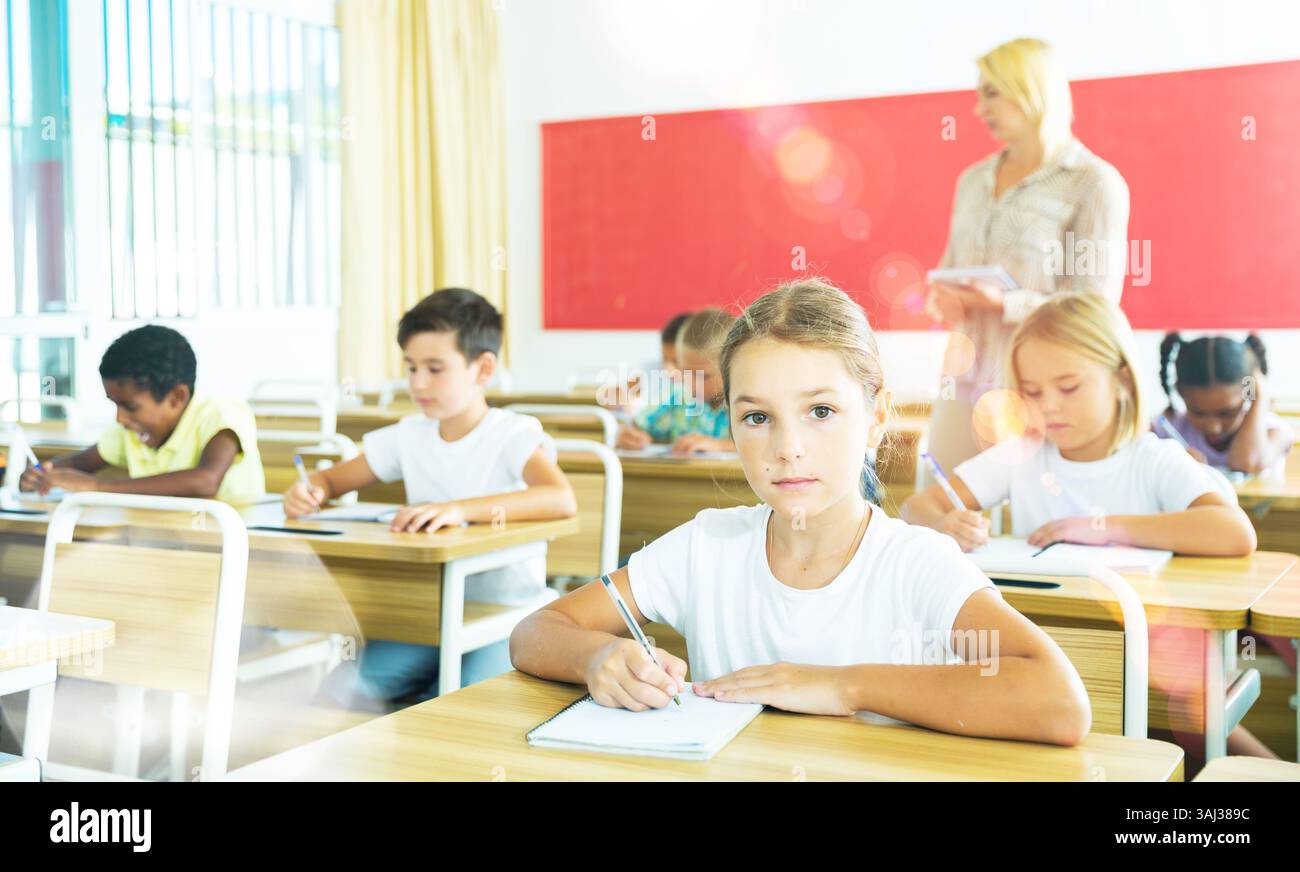 School girl working at lesson in classroom Stock Photo - Alamy