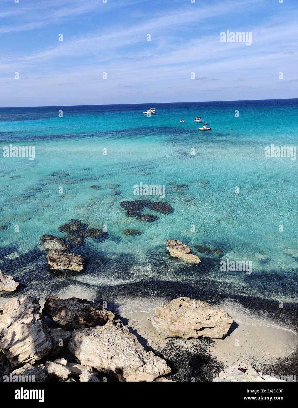 Crystal-clear waters and sunlit stones. Cyprus at its most breathtaking, where the sea paints every shade of blue. - Smartphone Captured Stock Image