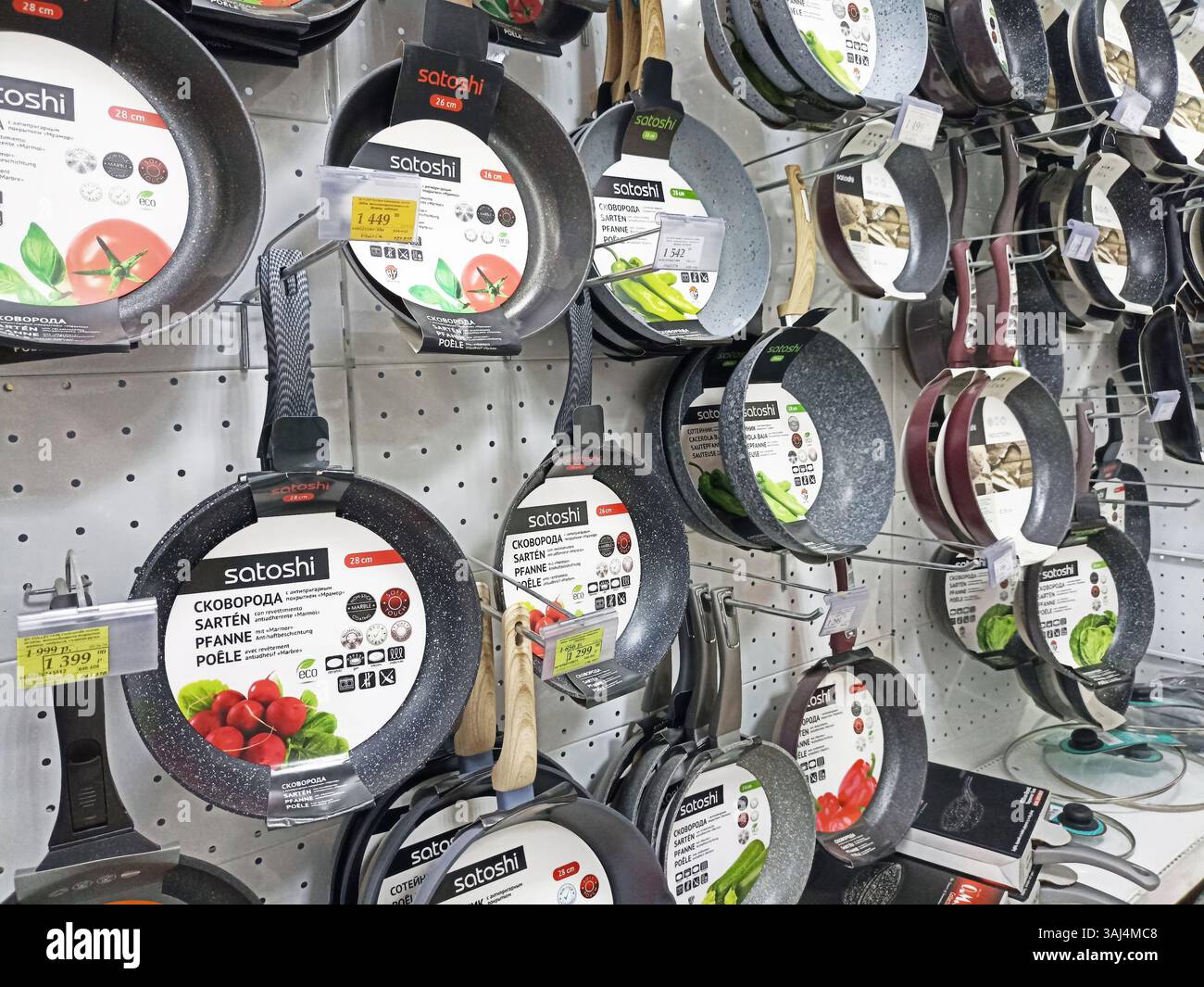 Variety of nonstick pans on display in kitchenware store aisle. Stock Photo
