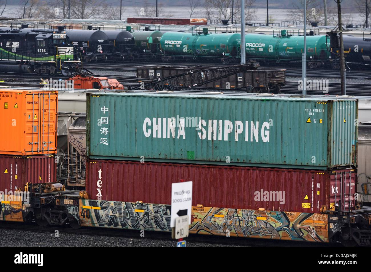 A Norfolk Southern freight pulls a consist of shipping containers pulls ...