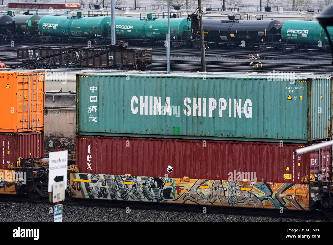 A Norfolk Southern freight pulls a consist of shipping containers pulls ...