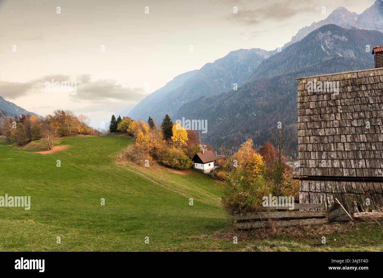 Tranquil autumn scene picturesque valley, with a cozy house surrounded vibrant colors. Julian alps Slovenia Stock Photo