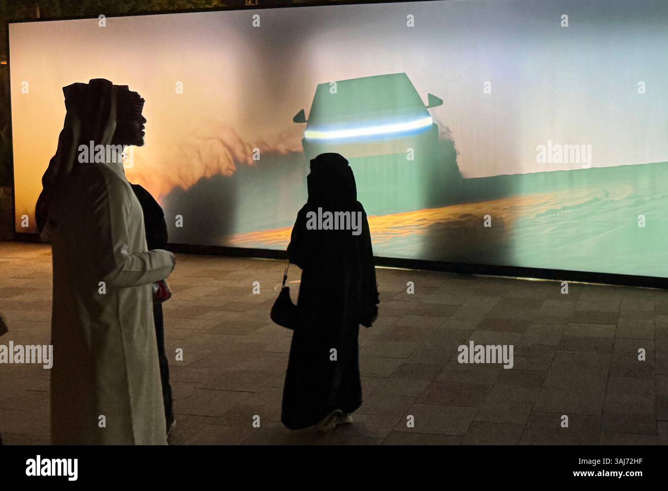 People attend a celebration for the start of Tesla operations in Saudi ...