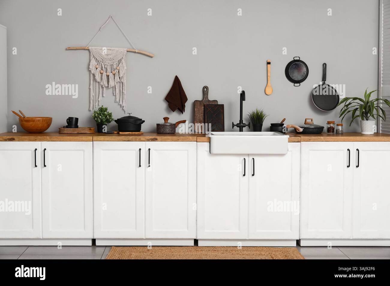 Interior of light kitchen with white counters, sink and utensils Stock ...