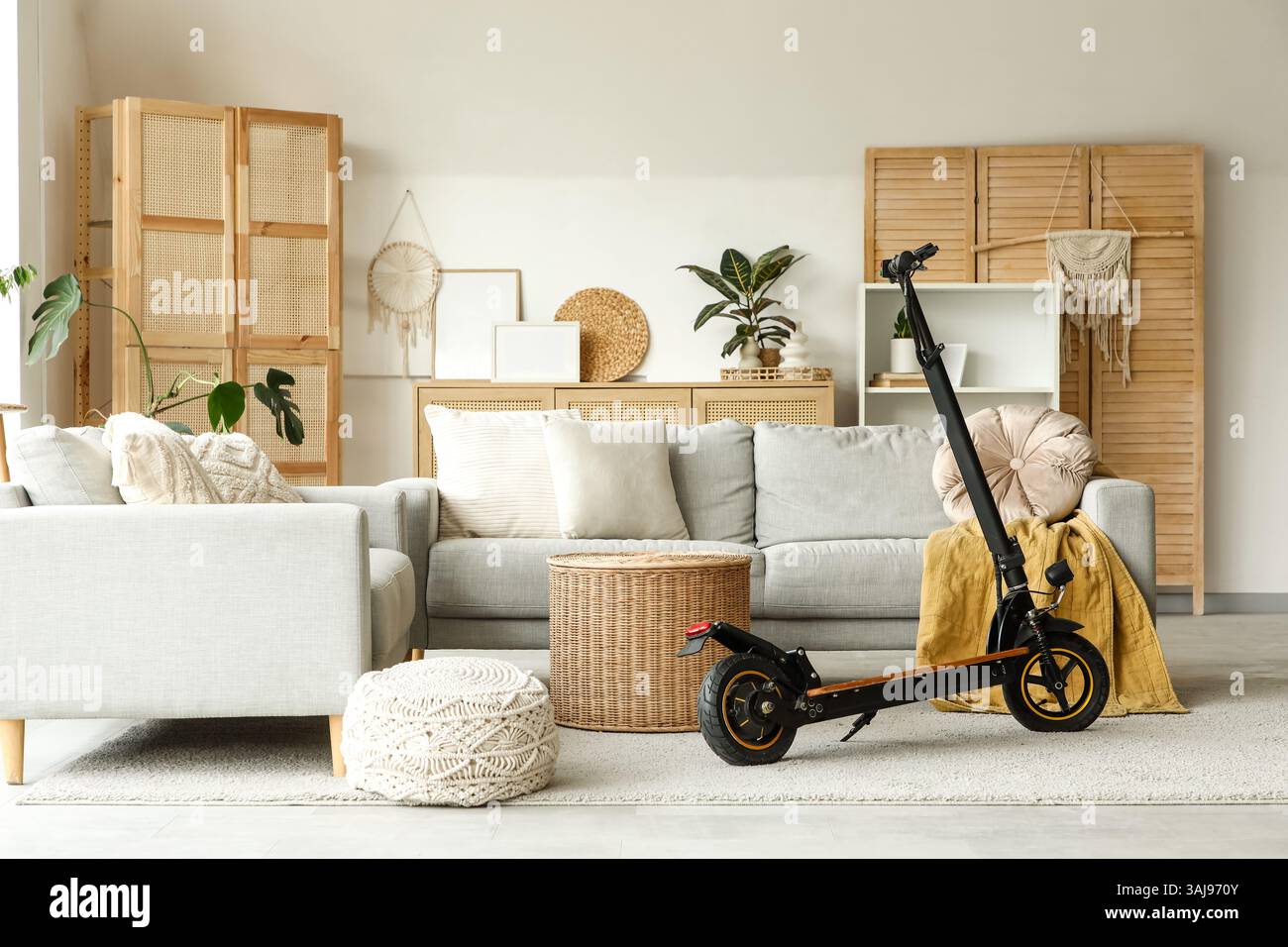 Scooter Inner Design Interior of living room with electric scooter and sofas Stock Photo - Alamy