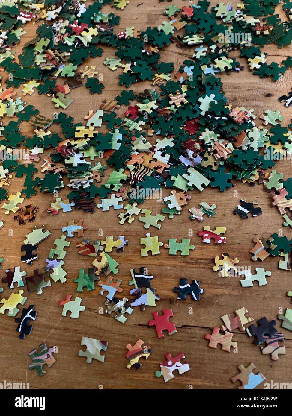 Scattered Jigsaw Puzzle Pieces on Wooden Table - Smartphone Captured Stock Image